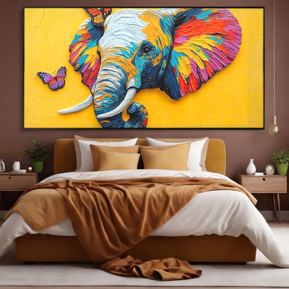 Tablou canvas cu tablou canvas cu elefant colorat si fluturi, in rama de aluminiu negru, pe perete intr-un dormitor
